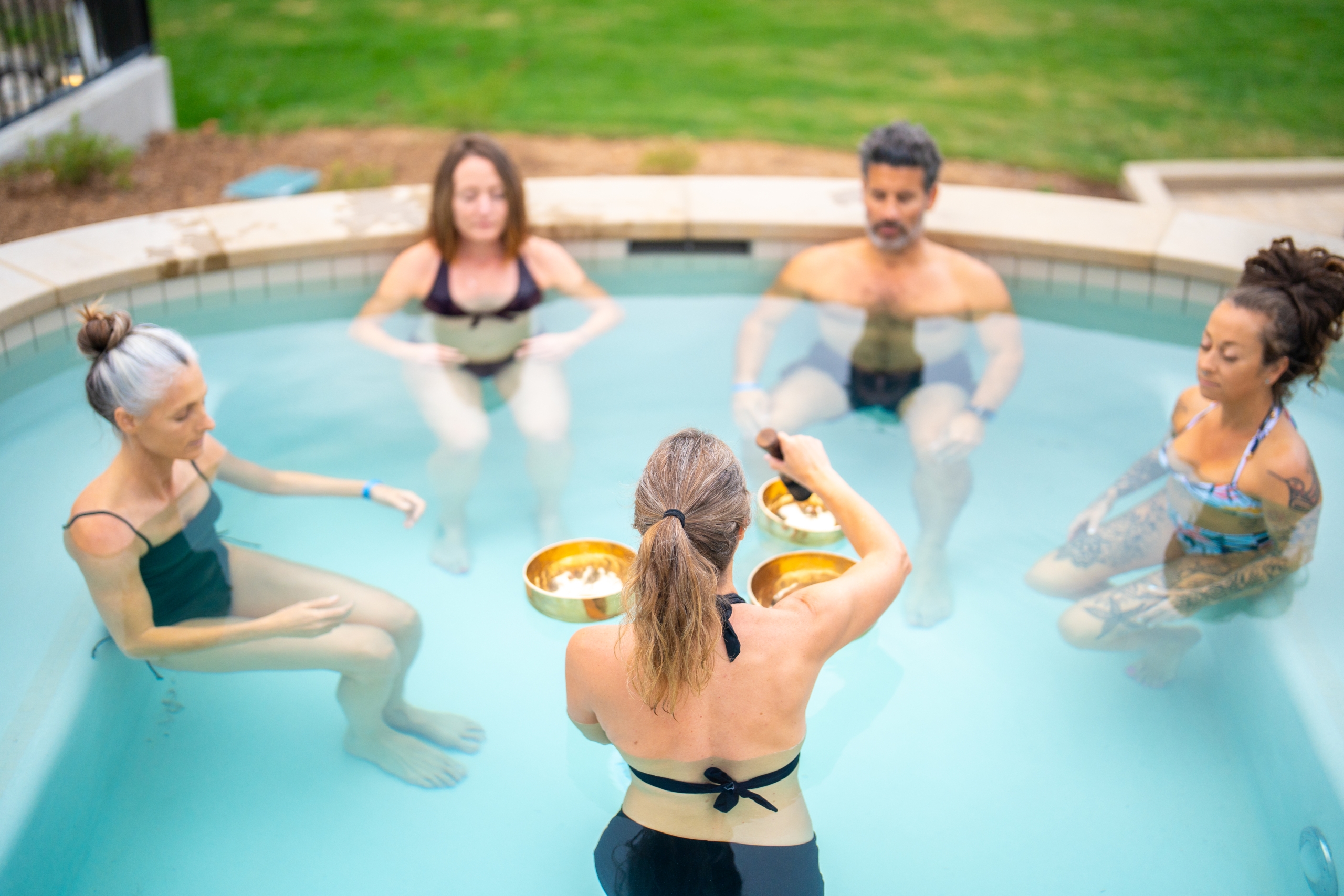 guests meditating in pool