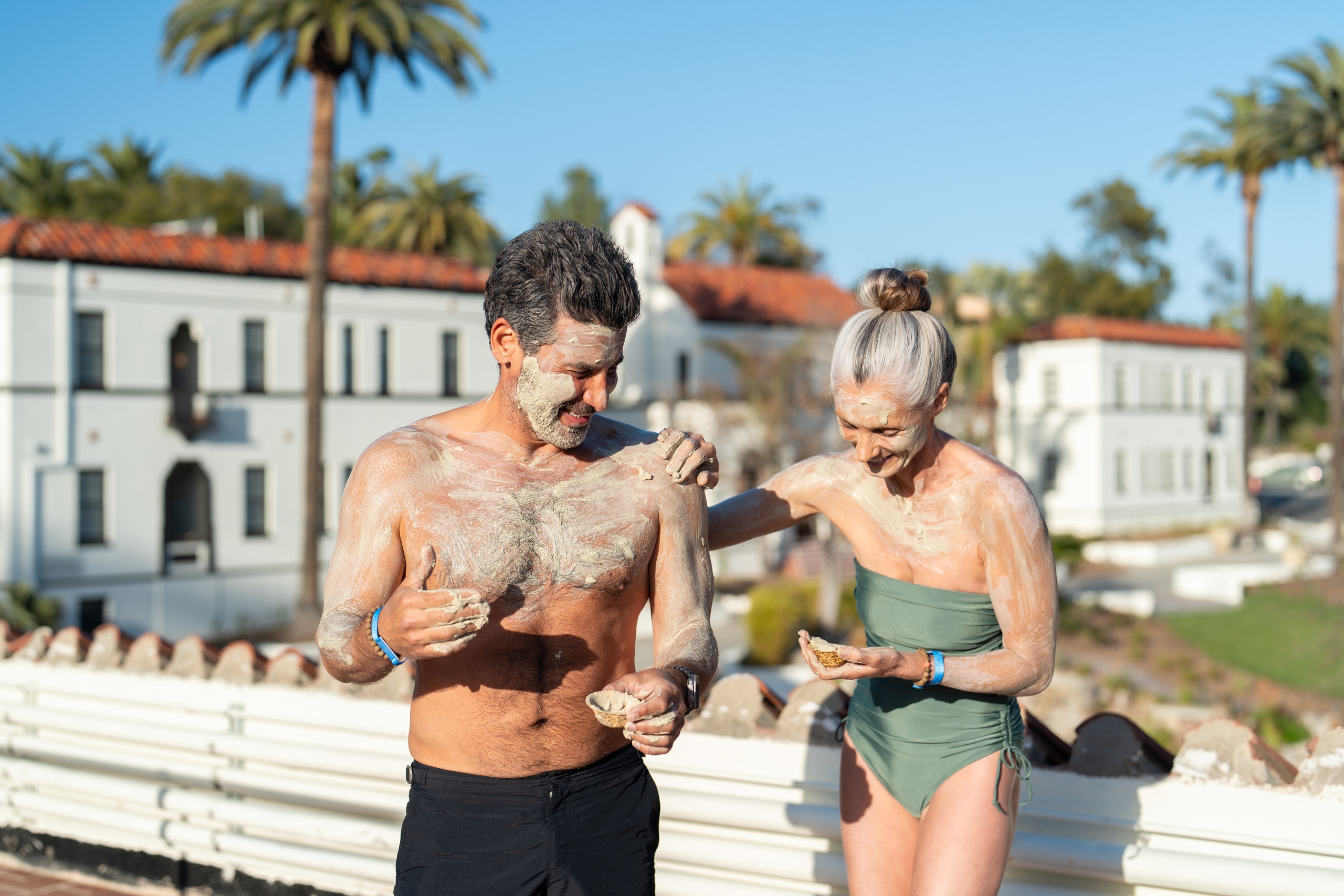 Couple experiencing outdoor clay bath.